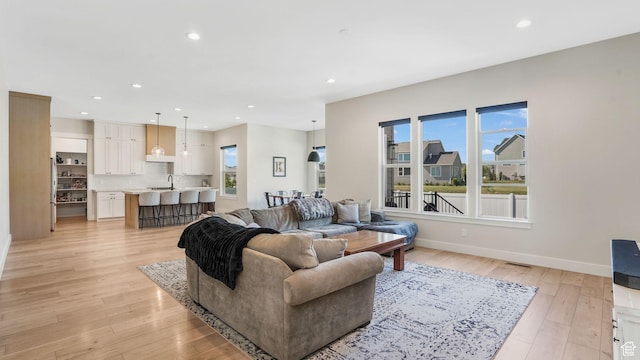 928 N Foxhunter Dr W, Farmington, UT 84025 - living area with recessed lighting, light wood-style floors, and baseboards