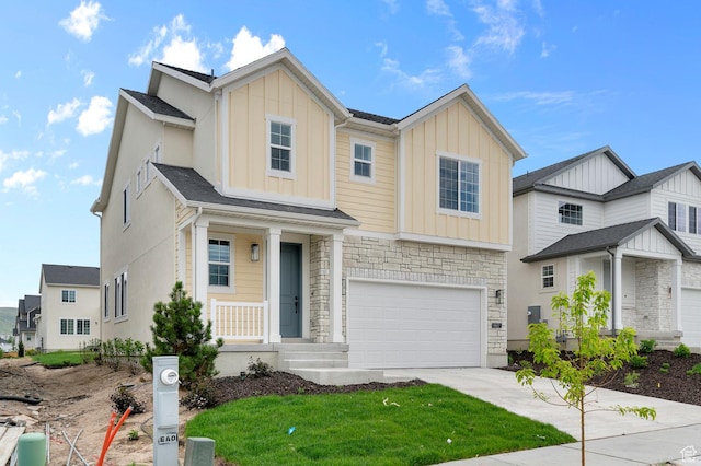 6627 W Spring Snow Ln, Herriman, UT 84096 - view of front of house with board and batten siding, driveway, an attached garage, and stone siding