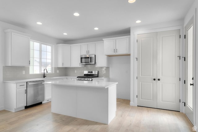 6627 W Spring Snow Ln, Herriman, UT 84096 - kitchen with appliances with stainless steel finishes, light countertops, white cabinetry, backsplash, and recessed lighting
