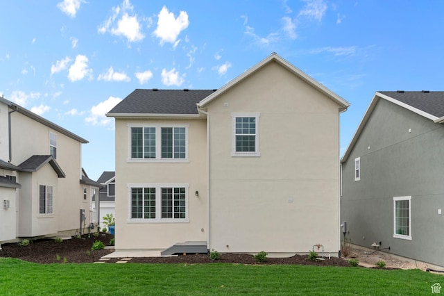 6627 W Spring Snow Ln, Herriman, UT 84096 - back of house with stucco siding and a yard