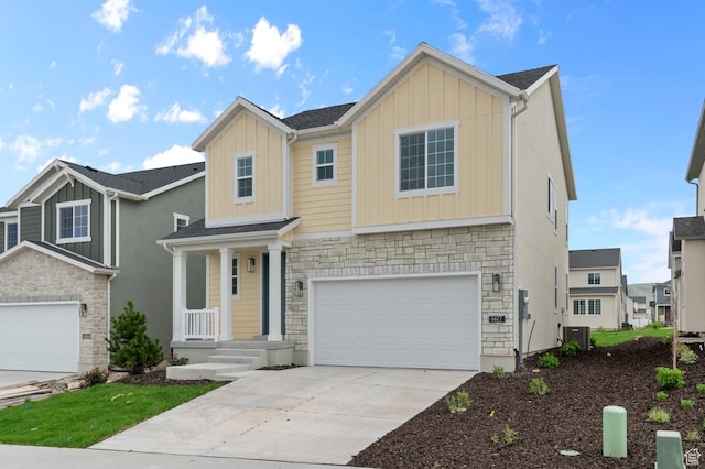 6627 W Spring Snow Ln, Herriman, UT 84096 - craftsman house with board and batten siding, stone siding, an attached garage, concrete driveway, and central air condition unit