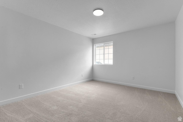 6627 W Spring Snow Ln, Herriman, UT 84096 - empty room featuring baseboards, light colored carpet, and a textured ceiling
