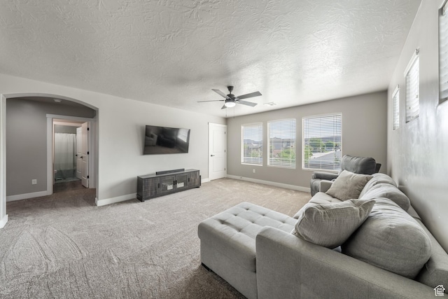 3459 S 2960 E, St George, UT 84790 - living room featuring a ceiling fan, baseboards, arched walkways, and a textured ceiling