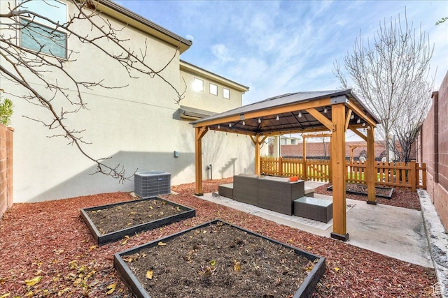 3459 S 2960 E, St George, UT 84790 - view of patio featuring a fenced backyard, a gazebo, cooling unit, a vegetable garden, and an outdoor living space
