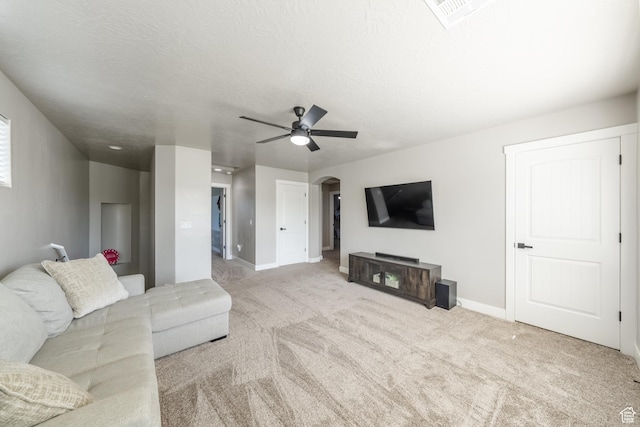 3459 S 2960 E, St George, UT 84790 - carpeted living room with arched walkways, a ceiling fan, visible vents, and baseboards