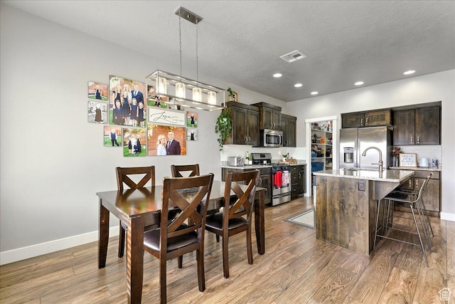 3459 S 2960 E, St George, UT 84790 - dining space featuring baseboards, recessed lighting, a textured ceiling, and light wood-style flooring