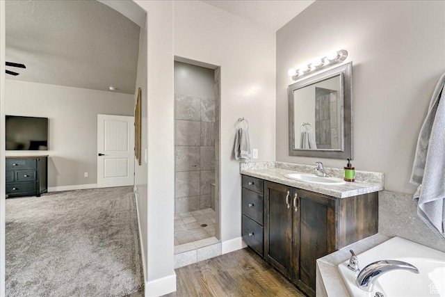 3459 S 2960 E, St George, UT 84790 - full bathroom with baseboards, a tub to relax in, vanity, and tiled shower