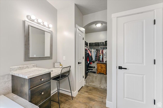 3459 S 2960 E, St George, UT 84790 - bathroom with a spacious closet, baseboards, vanity, and wood finished floors