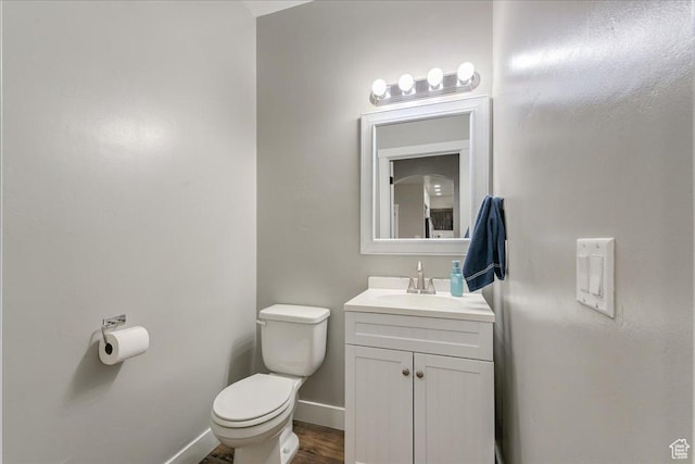 3459 S 2960 E, St George, UT 84790 - half bath with wood finished floors, baseboards, vanity, and toilet