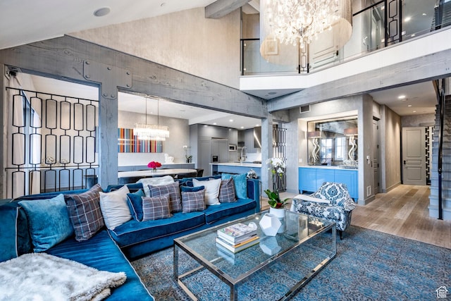 41 E Silver Star Ct Unit C-19, Park City, UT 84060 - living room featuring a chandelier, a high ceiling, and wood finished floors