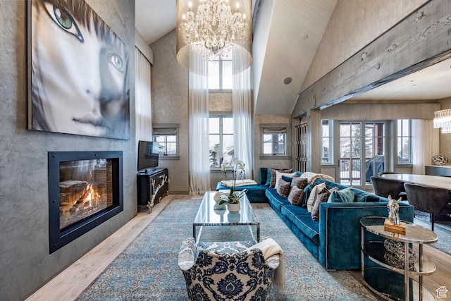 41 E Silver Star Ct Unit C-19, Park City, UT 84060 - living area with a chandelier, wood finished floors, a glass covered fireplace, and a high ceiling