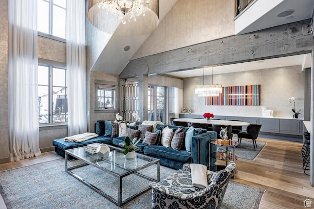 41 E Silver Star Ct Unit C-19, Park City, UT 84060 - living area with a chandelier, a towering ceiling, and light wood-type flooring