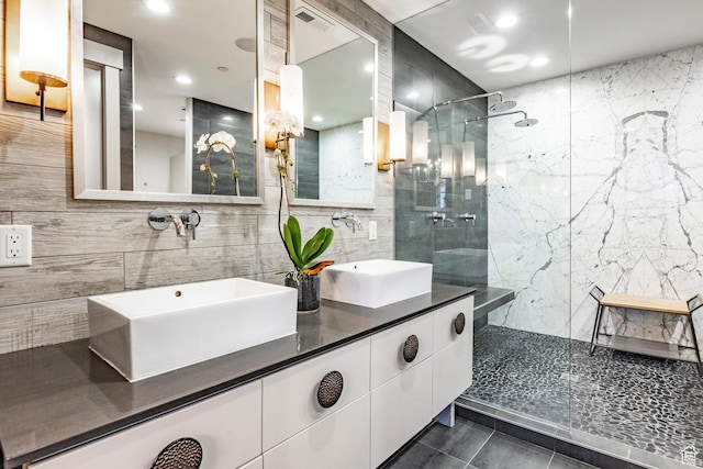 41 E Silver Star Ct Unit C-19, Park City, UT 84060 - bathroom featuring tiled shower, tile walls, double vanity, decorative backsplash, and recessed lighting