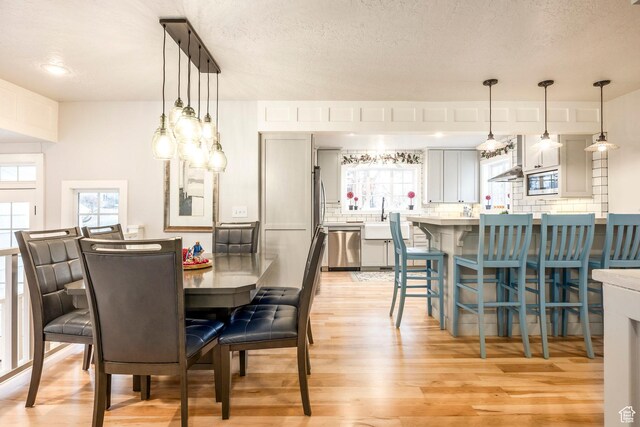 2760 E Spring Creek Rd, Holladay, UT 84117 - dining space with a textured ceiling and light hardwood / wood-style flooring