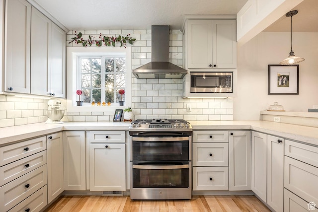 2760 E Spring Creek Rd, Holladay, UT 84117 - kitchen with stainless steel appliances, wall chimney exhaust hood, backsplash, and light stone countertops