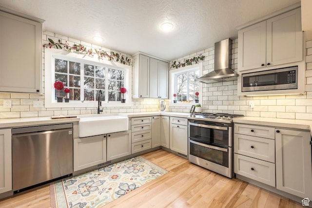 2760 E Spring Creek Rd, Holladay, UT 84117 - kitchen with sink, wall chimney exhaust hood, appliances with stainless steel finishes, and gray cabinets
