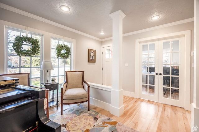 2760 E Spring Creek Rd, Holladay, UT 84117 - living area featuring a textured ceiling, french doors, ornamental molding, light wood-type flooring, and decorative columns