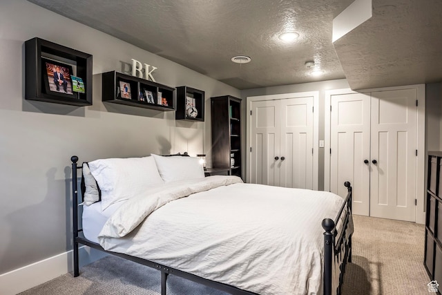 2760 E Spring Creek Rd, Holladay, UT 84117 - bedroom featuring a textured ceiling, light carpet, and two closets