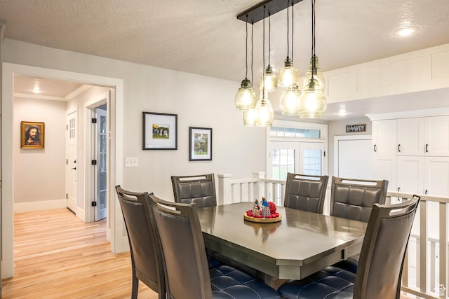 2760 E Spring Creek Rd, Holladay, UT 84117 - dining space featuring light hardwood / wood-style floors, a textured ceiling, crown molding, and french doors