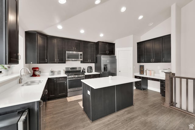 143 E 1825 N, North Ogden, UT 84414 - kitchen with stainless steel appliances, a kitchen island, vaulted ceiling, light wood-type flooring, and light countertops