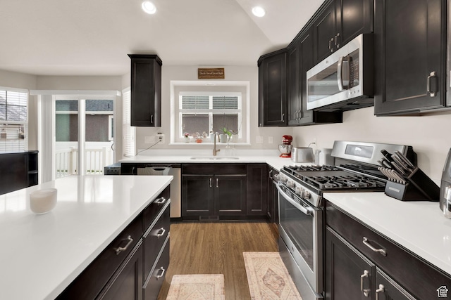 143 E 1825 N, North Ogden, UT 84414 - kitchen with recessed lighting, light countertops, appliances with stainless steel finishes, a sink, and wood finished floors