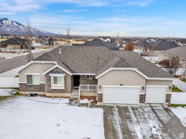 single story home with a garage, stucco siding, stone siding, driveway, and a residential view