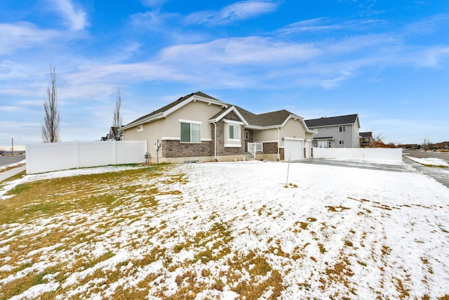 143 E 1825 N, North Ogden, UT 84414 - view of front facade with stucco siding, cooling unit, stone siding, a garage, and fence