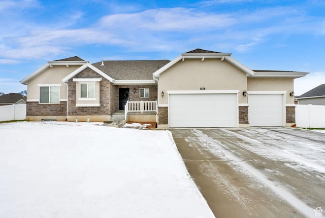 143 E 1825 N, North Ogden, UT 84414 - view of front of property with stone siding, an attached garage, stucco siding, and concrete driveway
