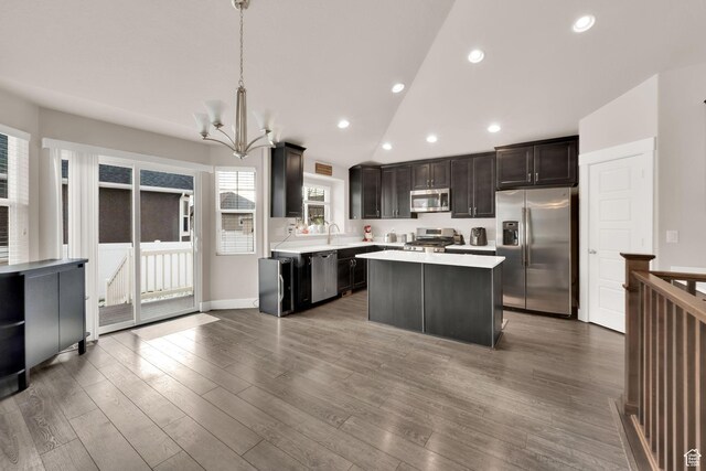 143 E 1825 N, North Ogden, UT 84414 - kitchen featuring appliances with stainless steel finishes, light countertops, a kitchen island, vaulted ceiling, and a chandelier