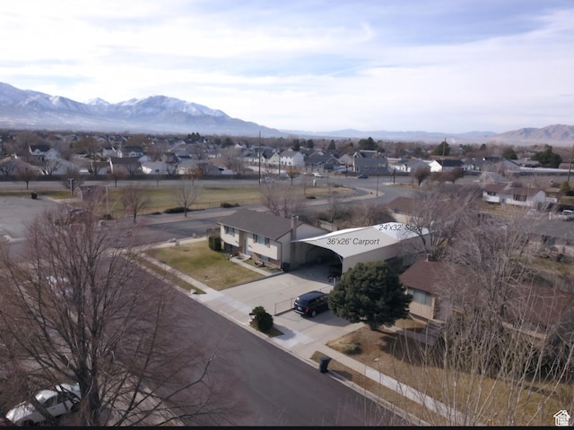 birds eye view of property with a mountain view and a residential view