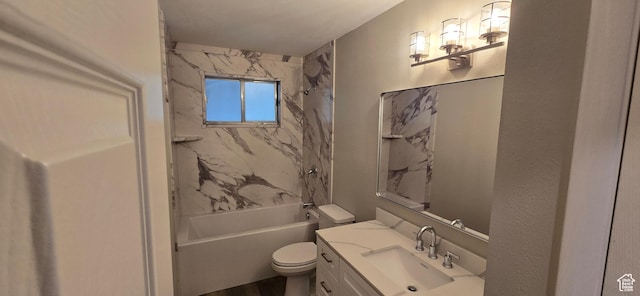 bathroom featuring toilet, vanity, and tub / shower combination