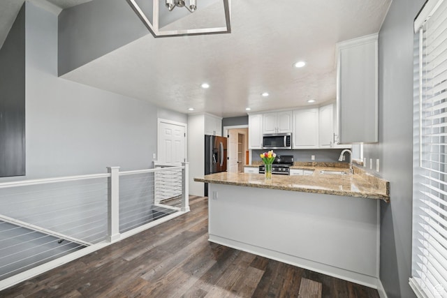854 S 200 E, Farmington, UT 84025 - kitchen with stainless steel appliances, a peninsula, a sink, white cabinetry, and dark wood finished floors