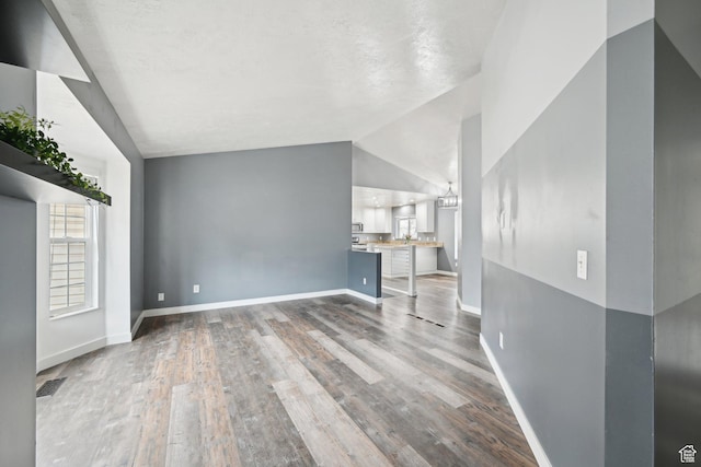 854 S 200 E, Farmington, UT 84025 - unfurnished living room featuring baseboards, vaulted ceiling, and wood finished floors