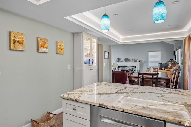 7996 S Sunnyoak Cir E, Cottonwood Heights, UT 84121 - kitchen featuring light stone countertops, white cabinets, decorative light fixtures, hardwood / wood-style flooring, and a tray ceiling