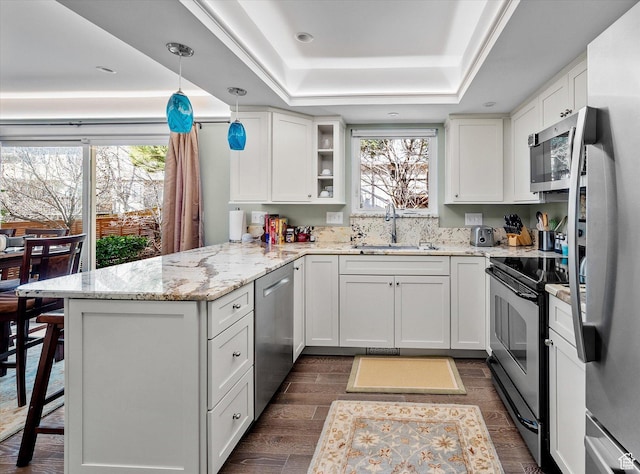 7996 S Sunnyoak Cir E, Cottonwood Heights, UT 84121 - kitchen with sink, white cabinets, a tray ceiling, and stainless steel appliances