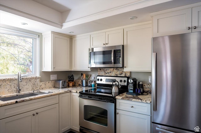 7996 S Sunnyoak Cir E, Cottonwood Heights, UT 84121 - kitchen featuring stainless steel appliances, light stone counters, white cabinetry, and tasteful backsplash