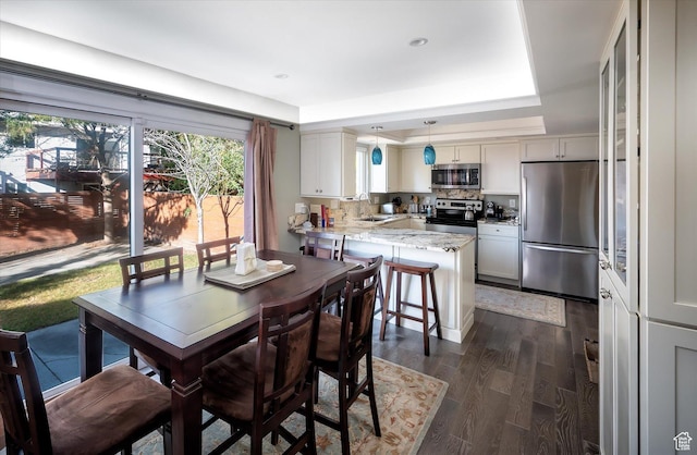 7996 S Sunnyoak Cir E, Cottonwood Heights, UT 84121 - dining room with a raised ceiling, dark hardwood / wood-style flooring, and sink