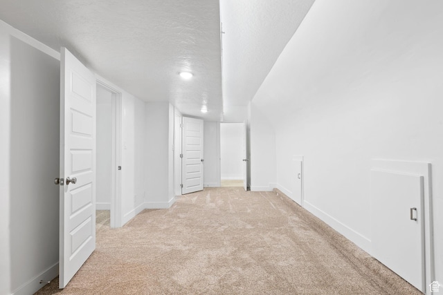 basement with light carpet and a textured ceiling