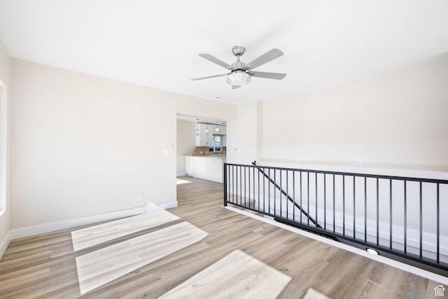 empty room featuring ceiling fan and light wood-type flooring