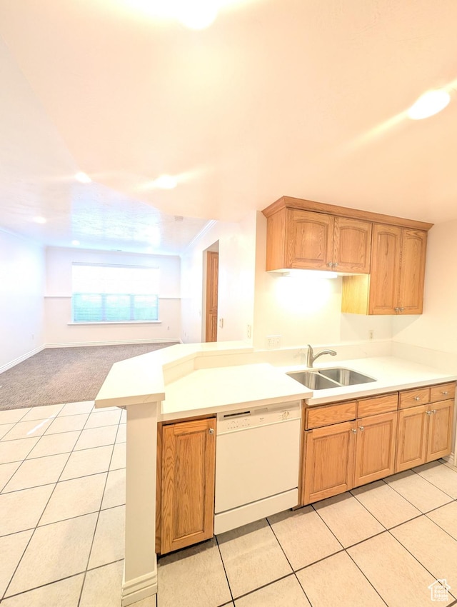 kitchen featuring kitchen peninsula, dishwasher, light tile patterned flooring, and sink