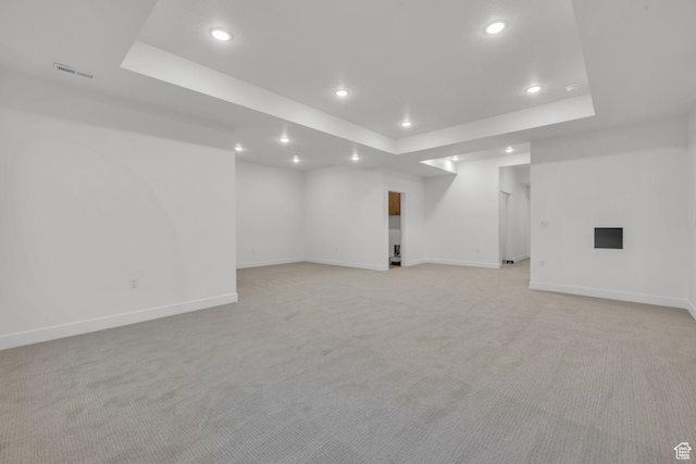 finished basement featuring recessed lighting, light colored carpet, and baseboards