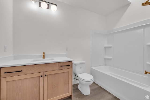 bathroom featuring toilet, wood finished floors, and vanity