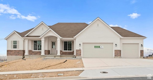 99 E 1590 S Unit 31, Salem, UT 84653 - view of front facade with an attached garage, brick siding, and concrete driveway