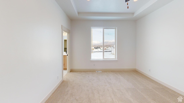 99 E 1590 S Unit 31, Salem, UT 84653 - empty room featuring a raised ceiling, light colored carpet, ceiling fan, and baseboards