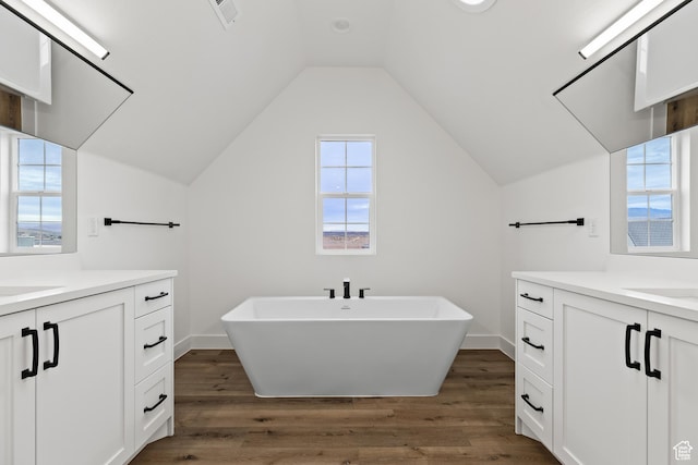 1539 W 2130th Cir S, St George, UT 84770 - bathroom featuring vanity, hardwood / wood-style flooring, vaulted ceiling, and a bathtub