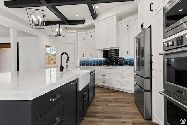 1539 W 2130th Cir S, St George, UT 84770 - kitchen featuring coffered ceiling, stainless steel appliances, pendant lighting, a center island with sink, and beamed ceiling