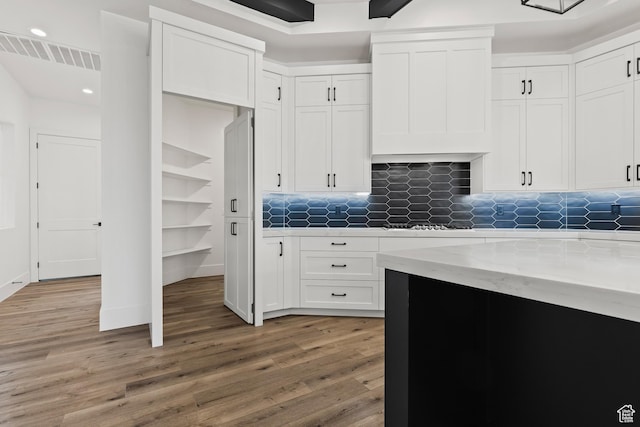 1539 W 2130th Cir S, St George, UT 84770 - kitchen with decorative backsplash, light stone counters, gas stovetop, hardwood / wood-style flooring, and white cabinets