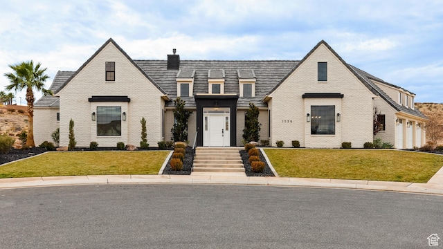 french country style house with a front yard