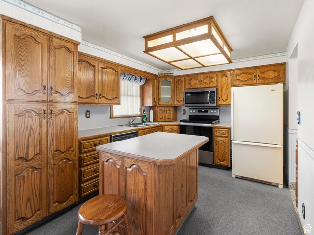 5304 W 20400 N, Plymouth, UT 84330 - kitchen with dark colored carpet, a center island, sink, and appliances with stainless steel finishes