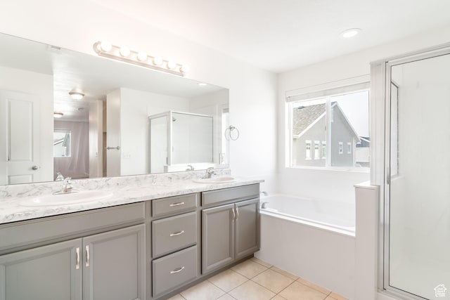 bathroom featuring tile patterned flooring, plenty of natural light, separate shower and tub, and vanity